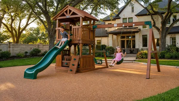 Children playing on a backyard swing set and slide over poured-in-place rubber safety surfacing