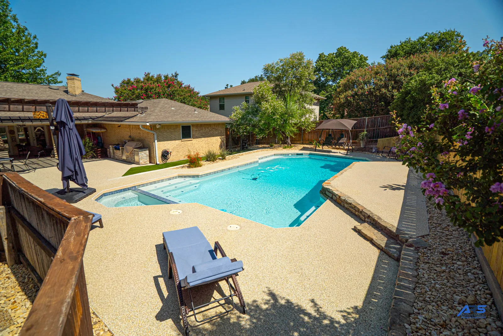Finished speckled rubber surface around a residential pool in Garland, Texas