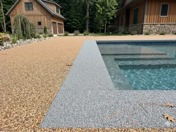 Two-tone tan and gray TPV rubber pool deck with a custom border accent